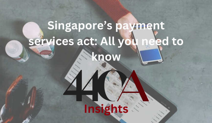 Singapore payments services act: title text over a top down view of a business counter where someone is using their phone to buy products