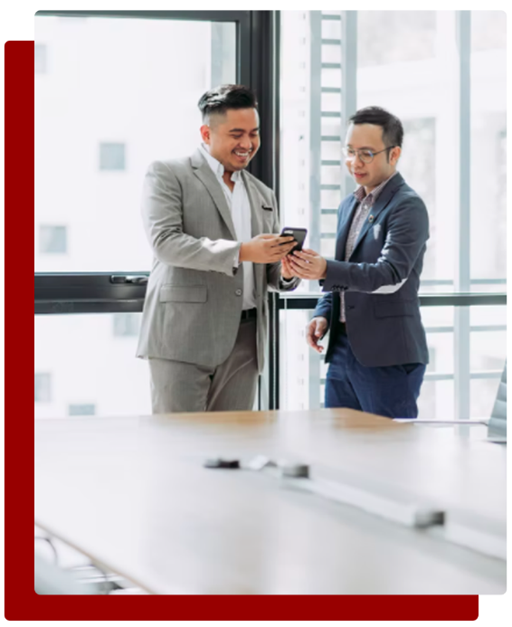 Two businessmen are having a discussion of ideas presented on a mobile phone.