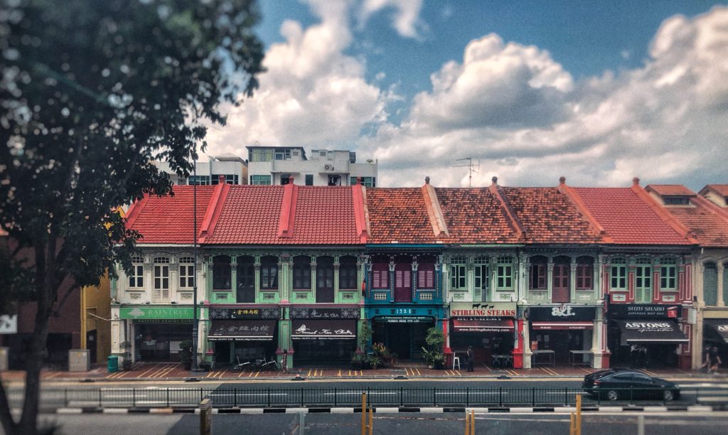 A front on perspective of a row of colourful shophouses in Joe Chiat