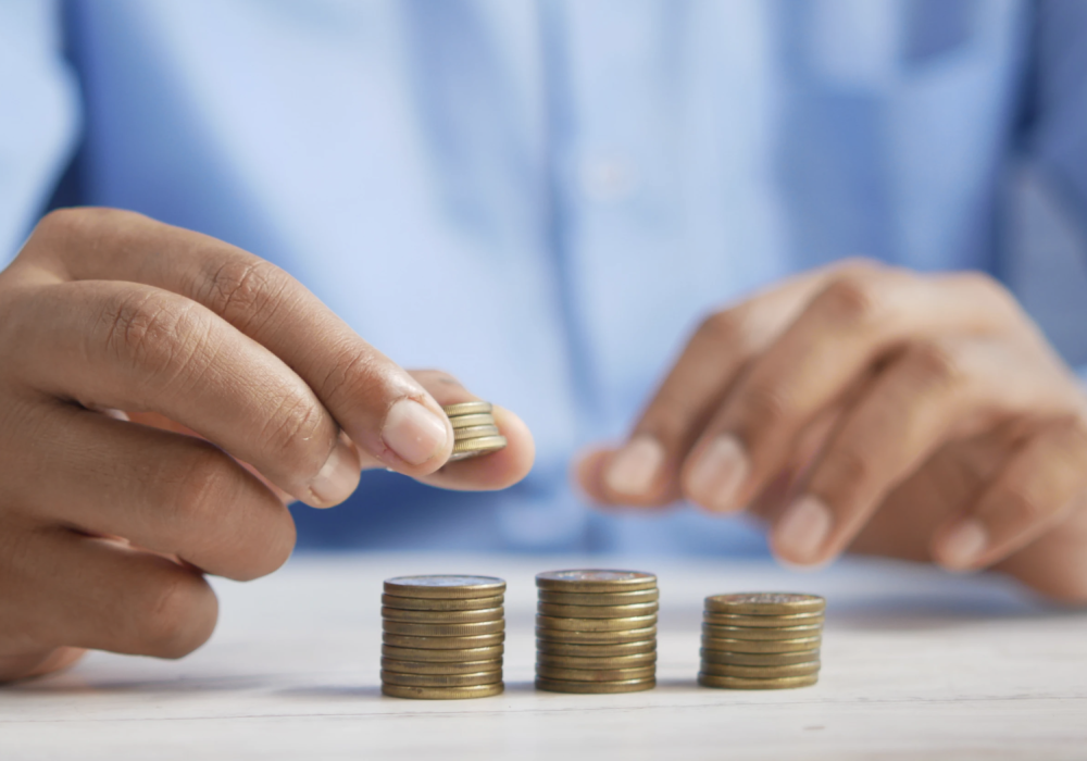 A man counting coins from his wealth